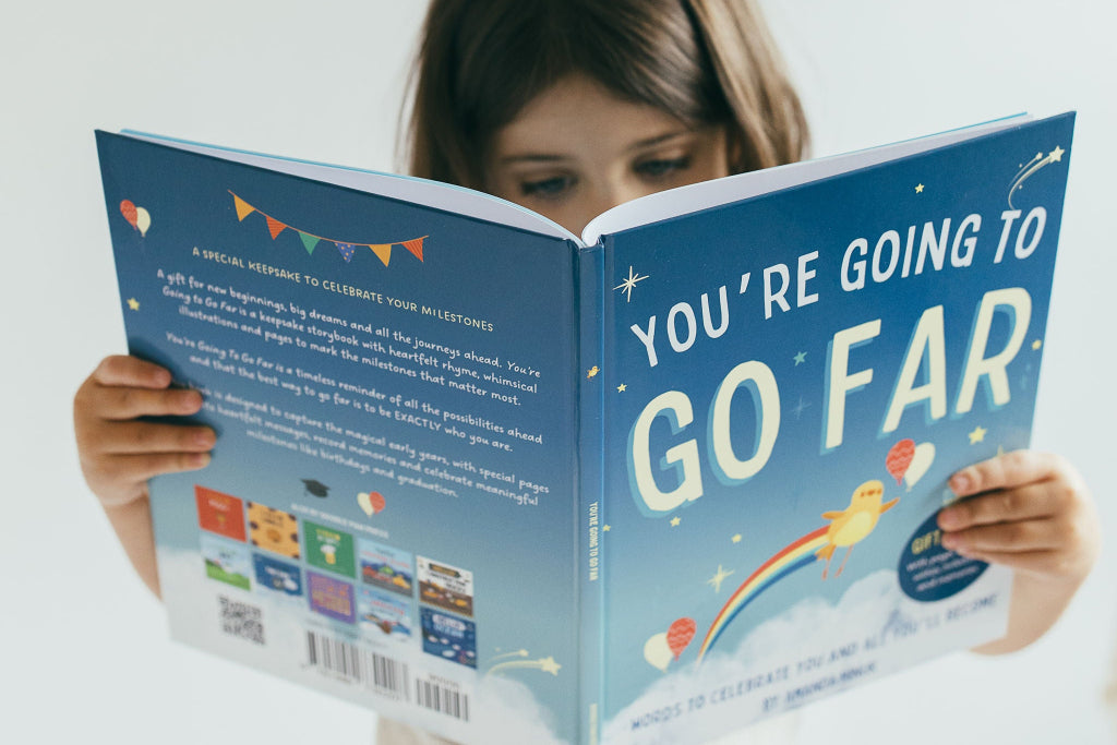 Girl holding open You're Going To Go Far Gift Edition